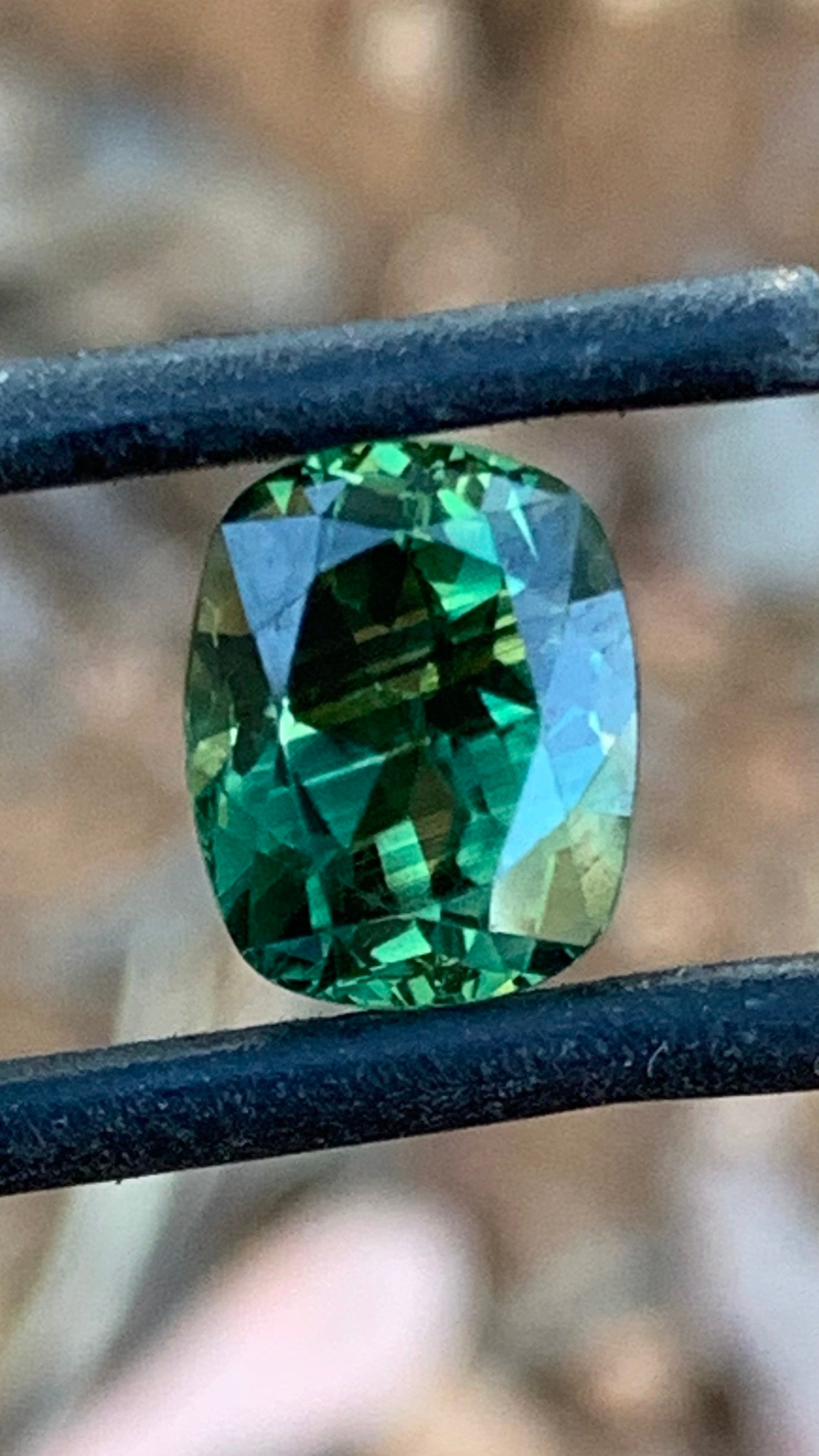 Natural Australian sapphire with vivid green and yellow stripes and unique colour play