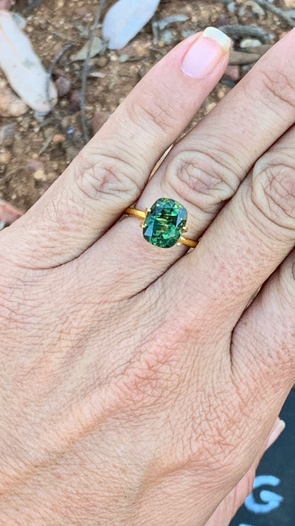 5.02ct Eye clean Australian sapphire with lively striped green and yellow colour zoning on hand for size reference