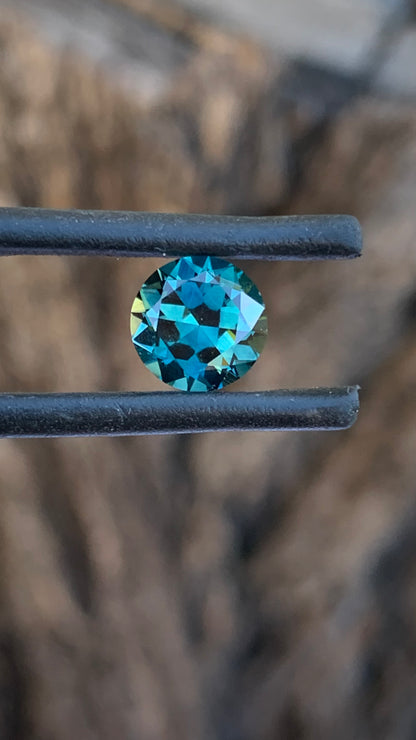Eye clean round Australian sapphire with vibrant aqua teal blue and green tones