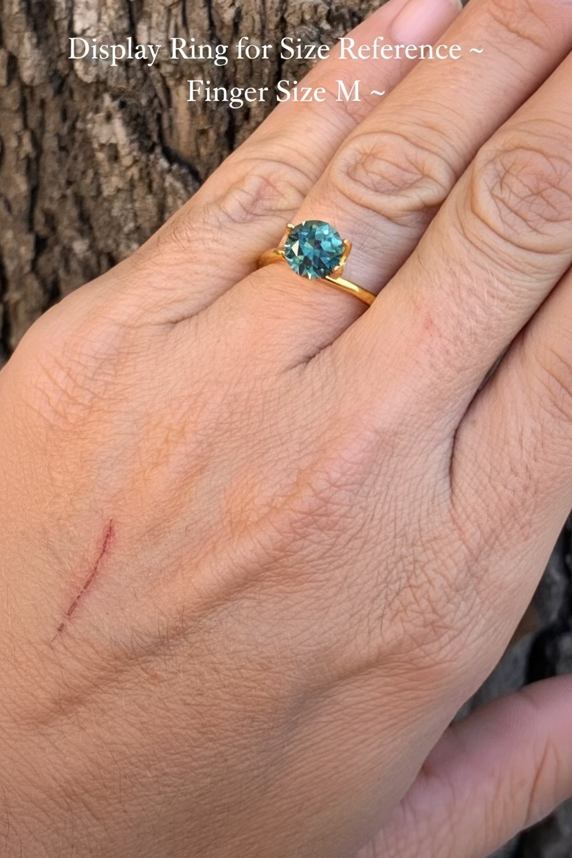 Teal Australian Parti Sapphire on finger for size reference
