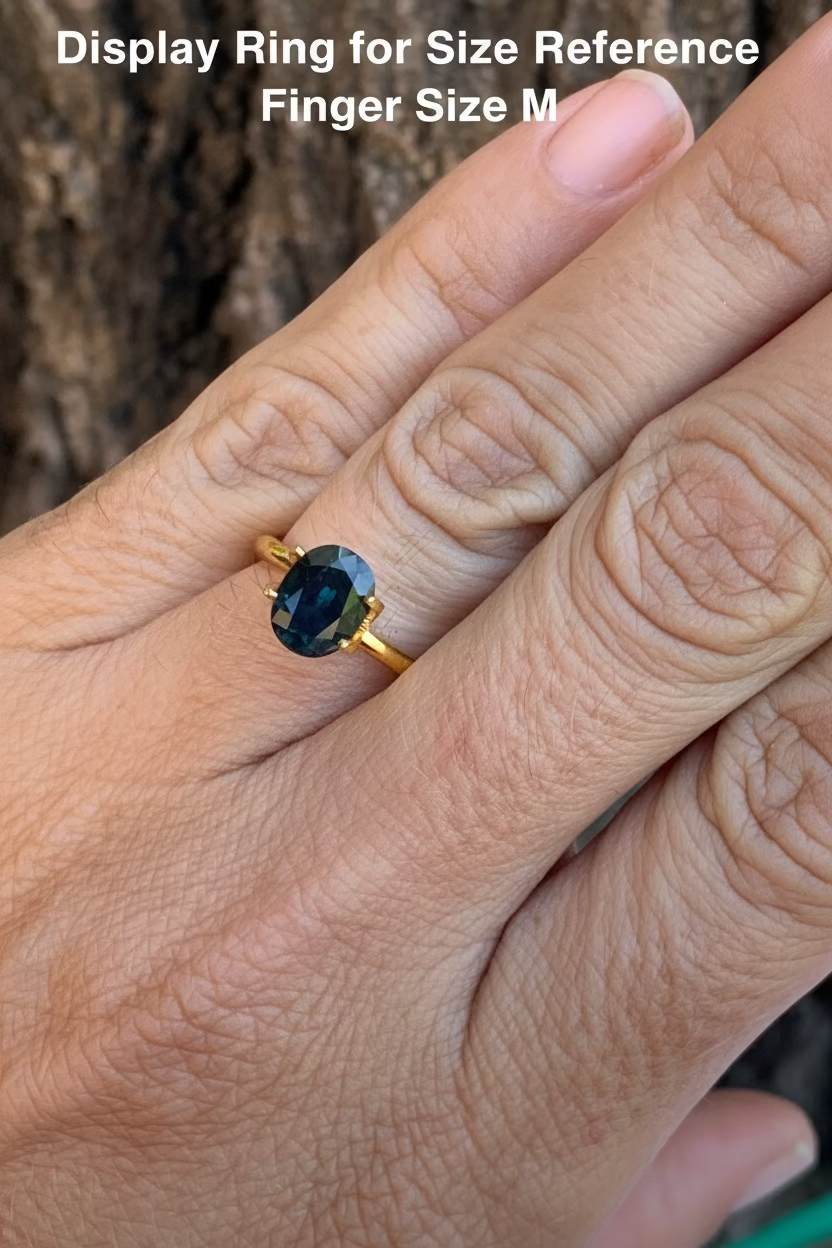 2.5ct Teal Australian Sapphire on a hand for size reference