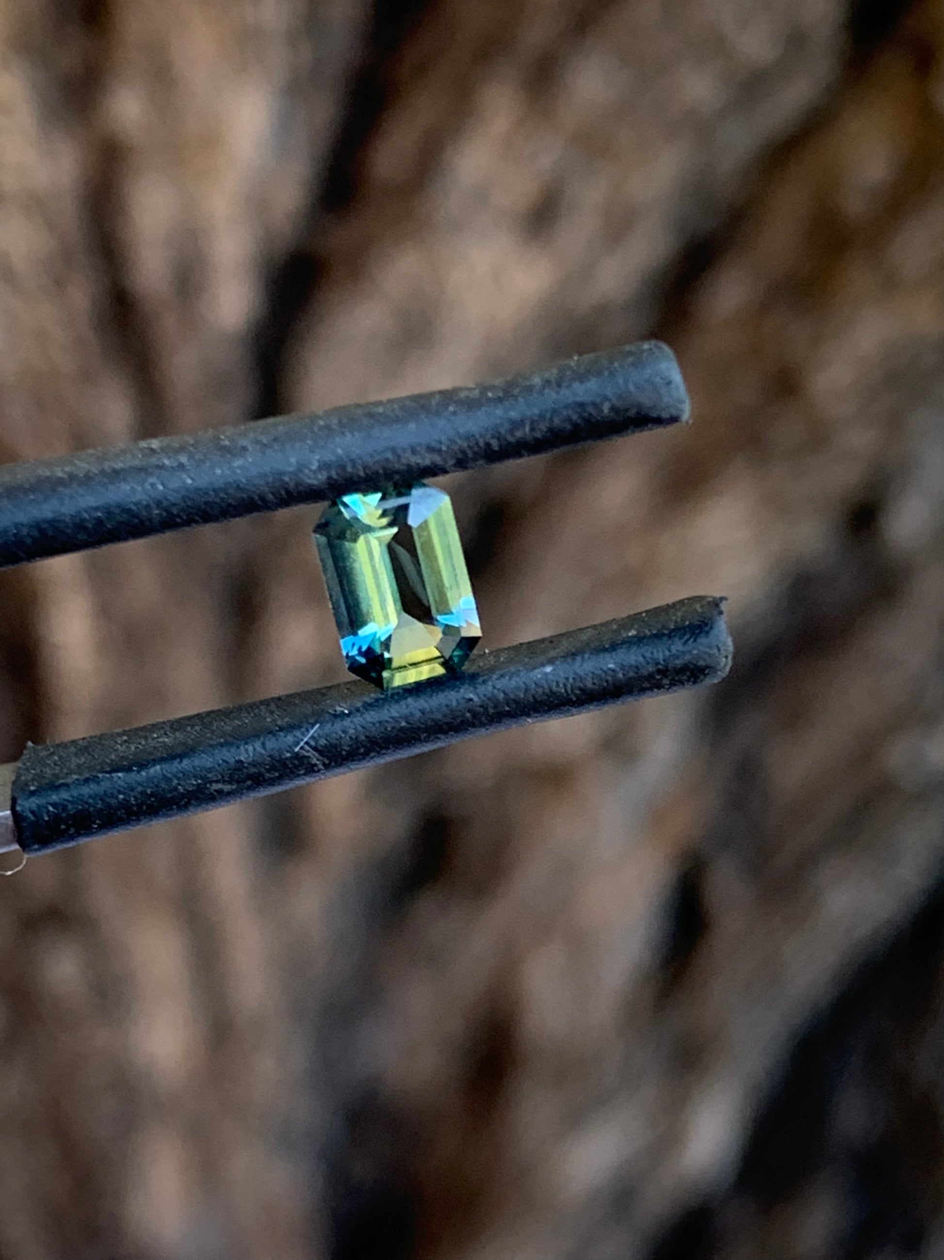 Natural teal Australian sapphire with crisp emerald cut and blue green tones