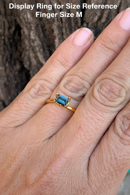0.72ct teal emerald cut Australian sapphire on a hand for size reference