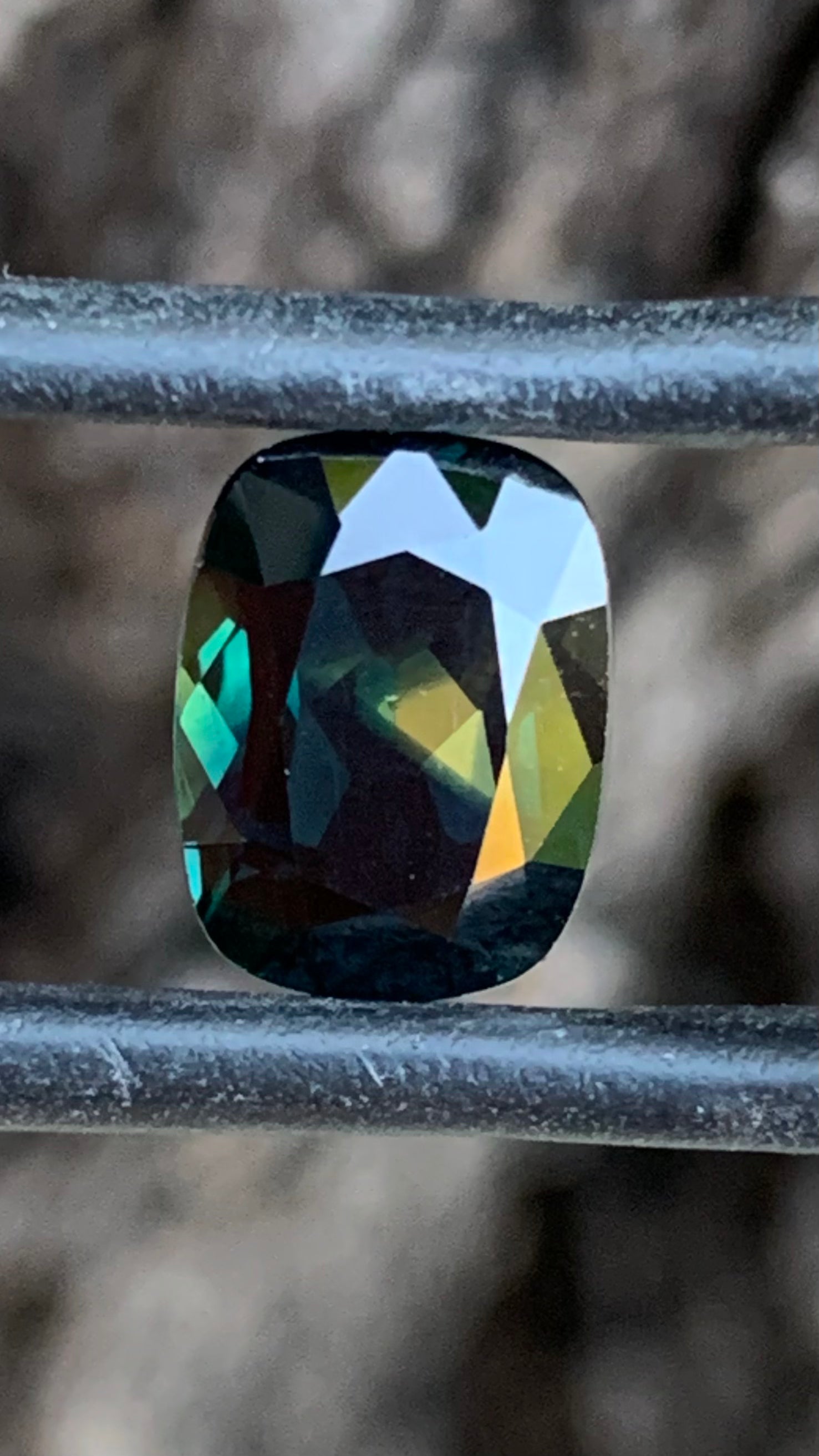 3.74ct cushion cut Australian sapphire with distinctive Pharaoh’s Eye yellow zoning