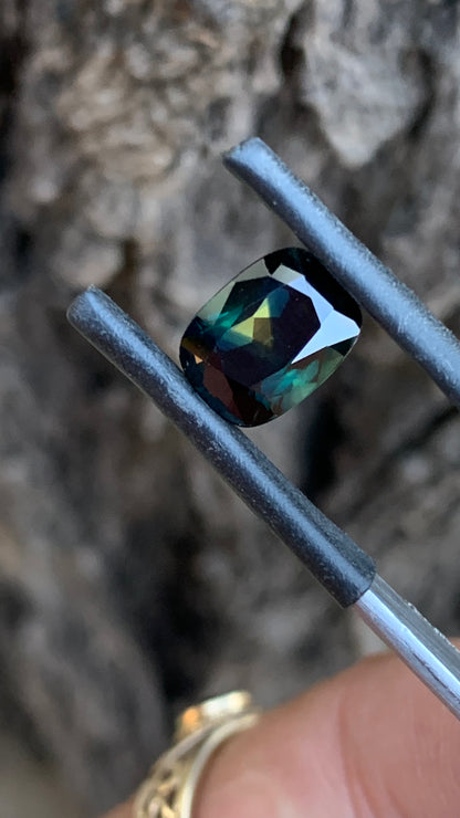 Eye clean heated Australian parti sapphire with deep moody colour and yellow triangle